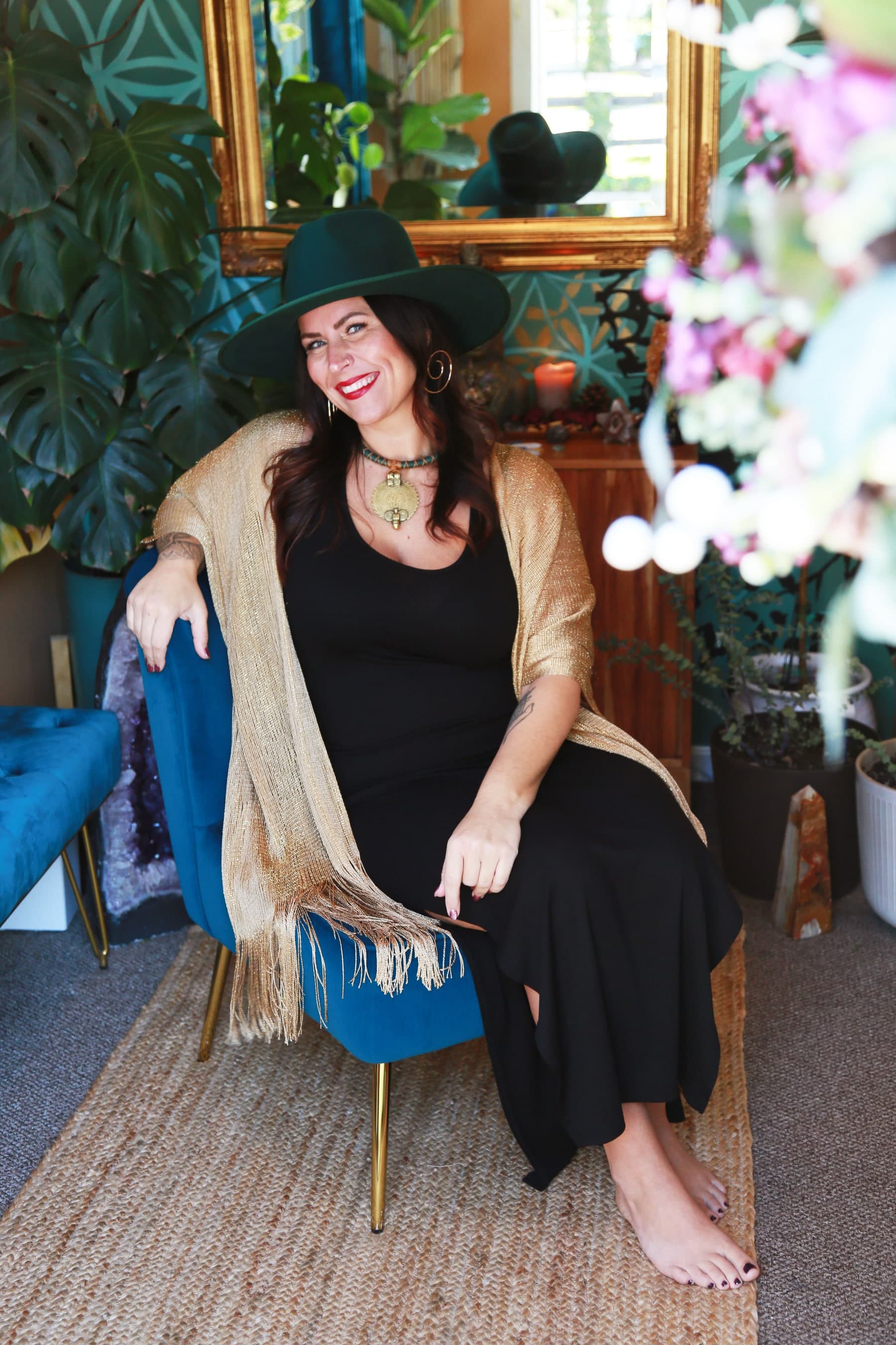 Kate Gajewski smiling in a blue chair at The Lightness of Being