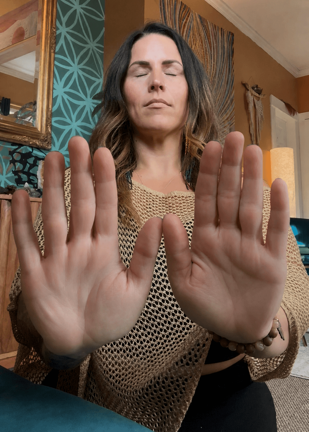 Kate Gajewski offering Reiki with both hands raised