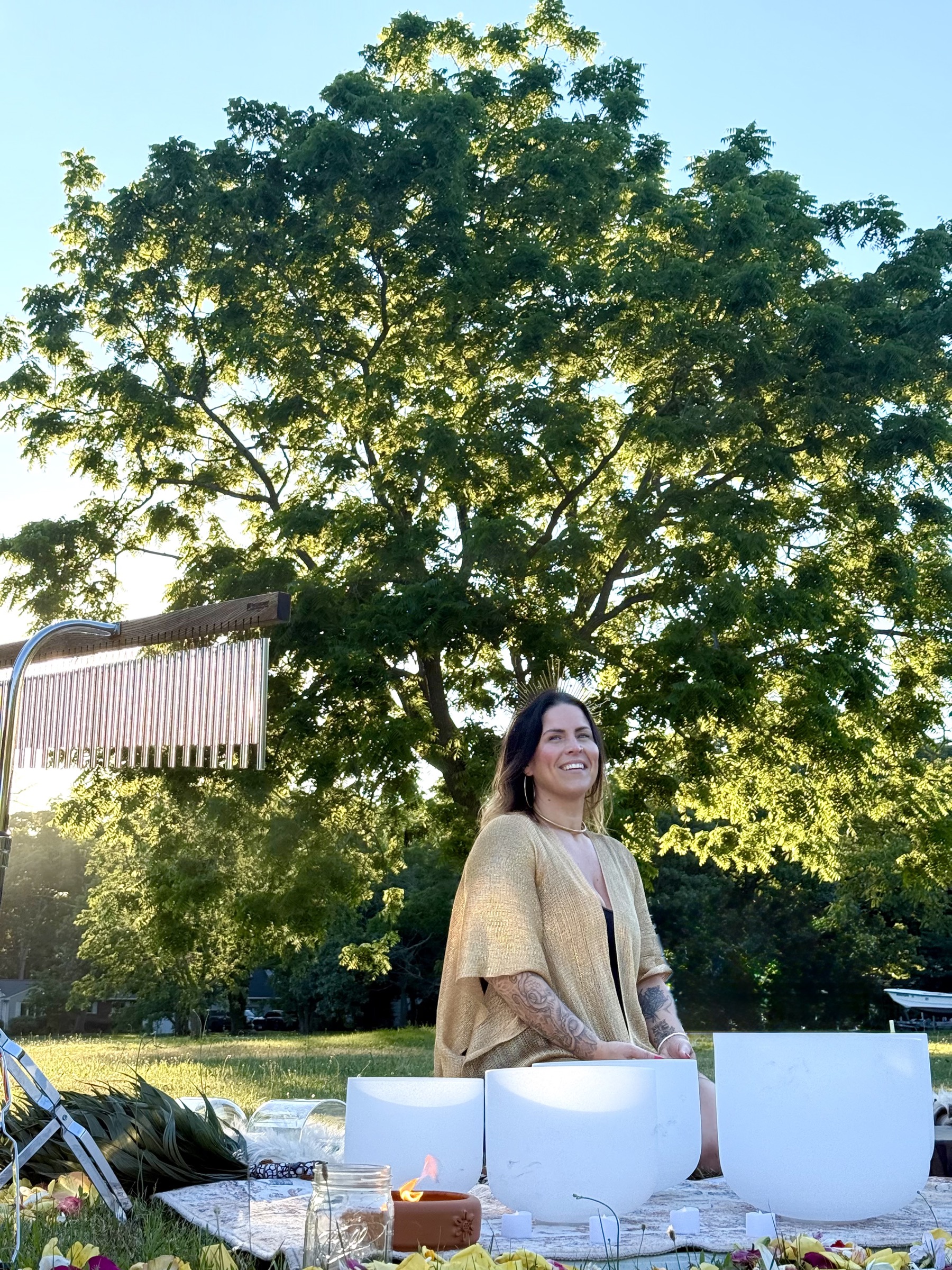 Kate leading a golden hour sound bath outdoors